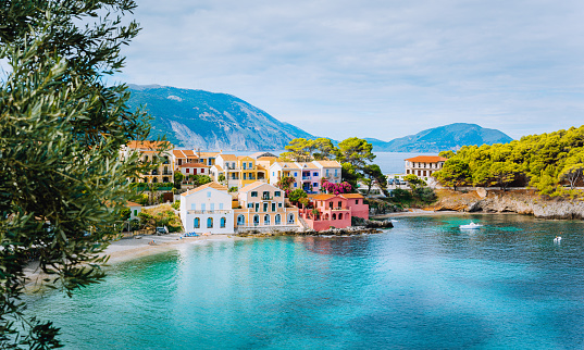 Panoramic view of Assos village in Kefalonia, Greece. Turquoise blue colored water in Mediterranean sea and beautiful cute colorful local houses.