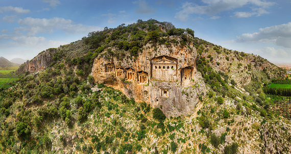 Above the river's sheer cliffs are the weathered façades of Lycian tombs cut from rock, circa 400 BC.