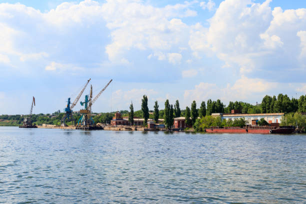 istock Heavy cranes in cargo port on the riverbank 1016227060