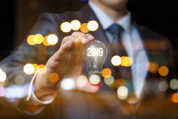 istock Businessman showing light bulb with glowing digits 2019. 1016227264