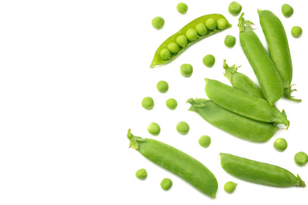 istock fresh green peas isolated on white background. top view 1016237490