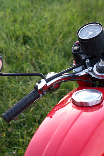 istock Part of a restored vintage motorcycle against a grass background 1016246100