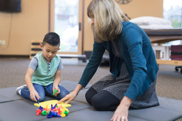 istock Occupational therapist works with a young ethnic boy 1016265702