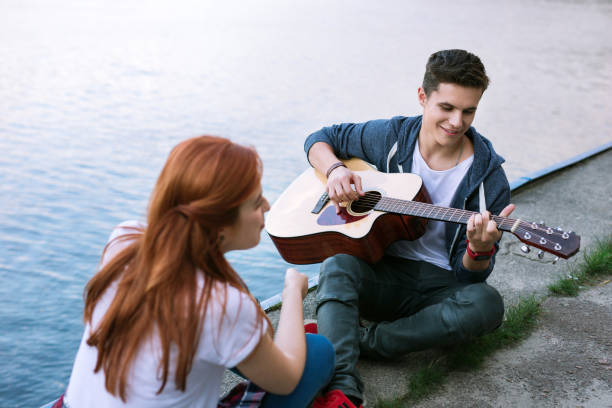 istock Positive joyful man playing the guitar Romantic date 1016269228
