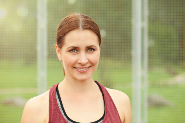 istock attractive 30 year old woman playing badminton 1016272656