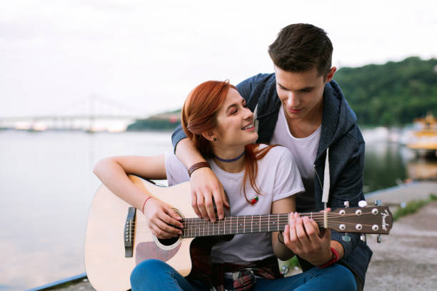 istock Nice happy woman playing the guitar Romantic date 1016272972