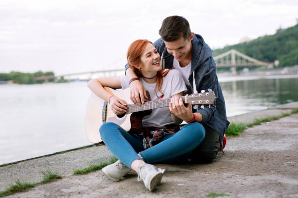 istock Delighted cheerful woman learning how to play the guitar 1016273222