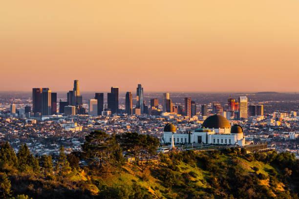 Los Angeles at sunset Los Angeles skyscrapers and Griffith Observatory at sunset griffith park photos stock pictures, royalty-free photos & images