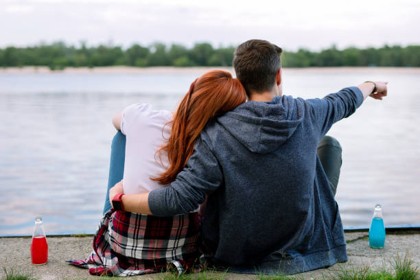 istock Nice young man showing a boat to his girlfriend 1016276078