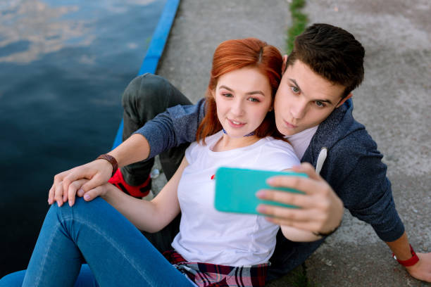 istock Beautiful nice woman looking into the smartphone camera 1016278812