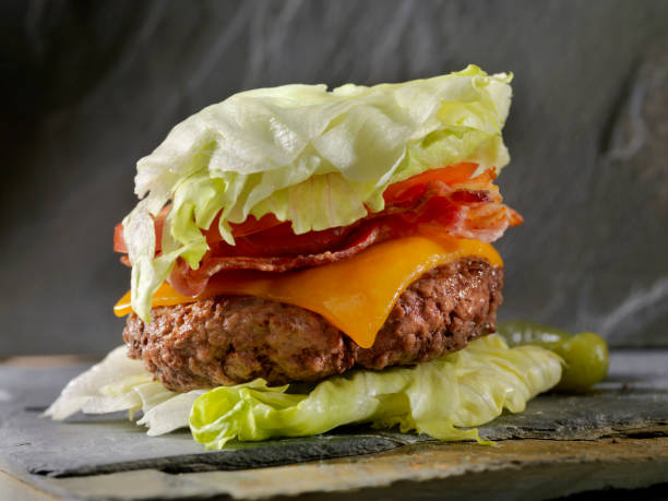 Low Carb - Lettuce Wrap Bacon CheeseBurger Low Carbohydrate - Lettuce Wrap Burger with bacon and cheese low carb diet stock pictures, royalty-free photos & images