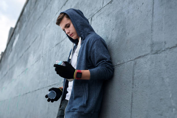 Serious young man looking at the spray paint