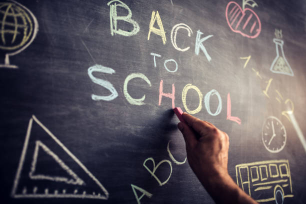 istock Little girl writing Back to School on blackboard 1016283994