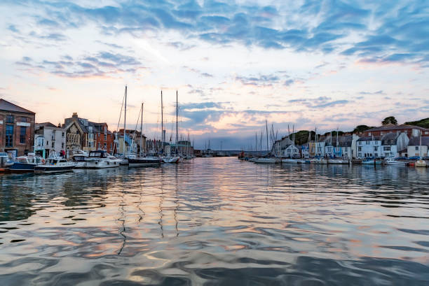 Weymouth Harbour Calm waters at Weymouth Harbour at dawn sunrise weymouth dorset stock pictures, royalty-free photos & images