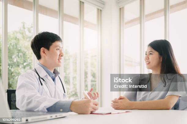 Doctor Having Consultation With Female Patient Stock Photo - Download Image Now - Medical Exam, Asian and Indian Ethnicities, Healthcare And Medicine