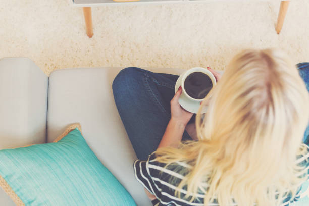 istock Happy young woman drinking coffee 1016316224