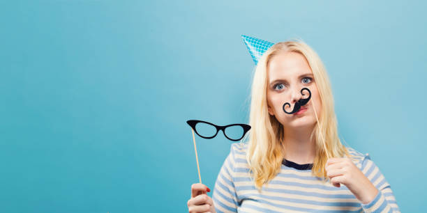 istock Young woman holding paper party sticks 1016316966
