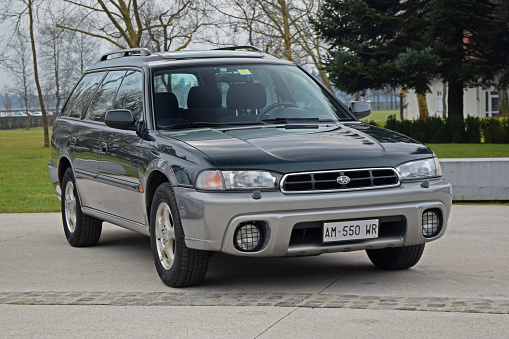 Brdo, Slovenia, January 27th, 2015: First generation of Subaru Outback (with years 1995-1999) parked on the street. The Outback model added partial protective plastic side body cladding for off-road conditions and raised the suspension to provide additional ground clearance.