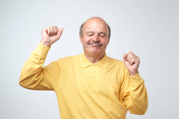 Mature happy man moving dancing over white background.
