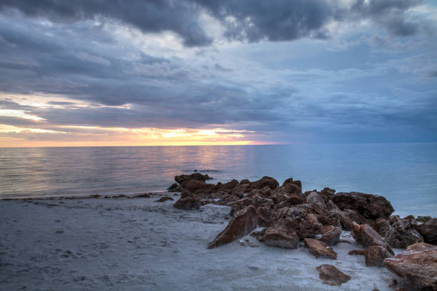istock Rain pours from dark clouds over Clam Pass Beach in Naples, Florida 1016332528