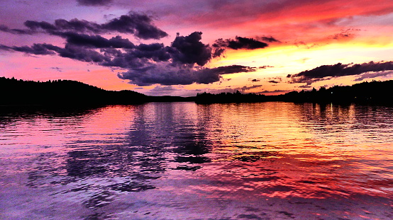 Water and sky with multicolored hues by the setting sun