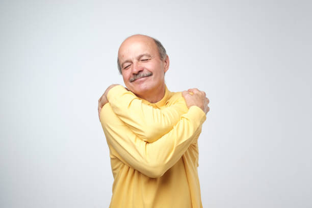 istock Closeup portrait confident smiling man hugging himself. I am the best concept. 1016348570