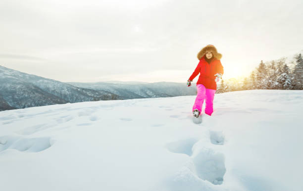 Woman walking through the deep snow