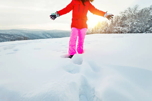 istock Woman walking through the deep snow 1016390098