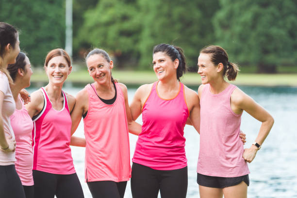 istock Women's running group stands around talking after a run 1016390150