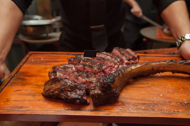 istock Cutting grill beef on wooden cutting board in the restaurant for dinner. 1016390464