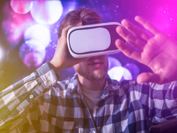 istock buisness man using virtual reality glasses, close up hand gestures with neon lights, concept 1016401184