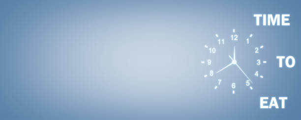 istock Clock with Time To Eat words on a blue background. Time To Eat Concept 1016416528
