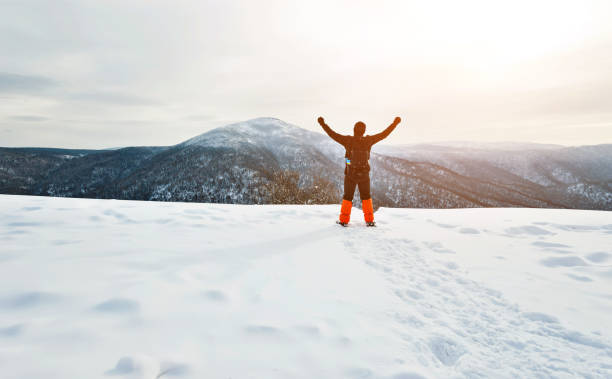 istock Man hiker on mountain top in winter 1016424218