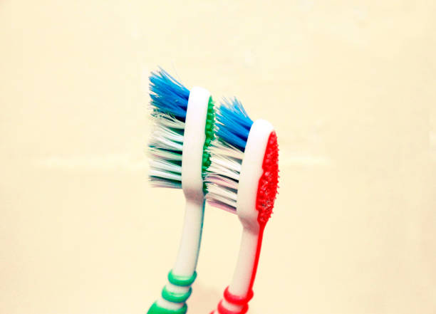 istock Green and red tooth brushes isolated on the white background 1016437050