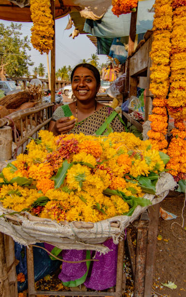 Calcutta, India - January 4, 2014:  Flower market in Calcutta. High angle view on flower market where Indian every day buy flowers for the Hindu ceremony. They love particularly garlands made of yellow or orange marigold flower heads. Very colorful sight.