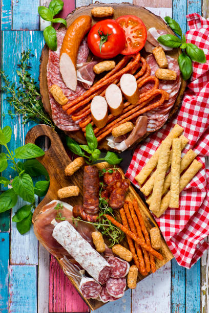 istock Cold smoked meat plate with pork chops, prosciutto, salami and bread sticks 1016454038