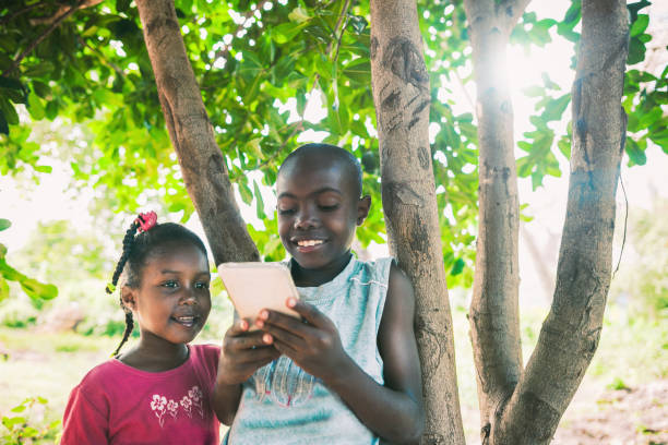 istock young african kids on mobile phone 1016454422