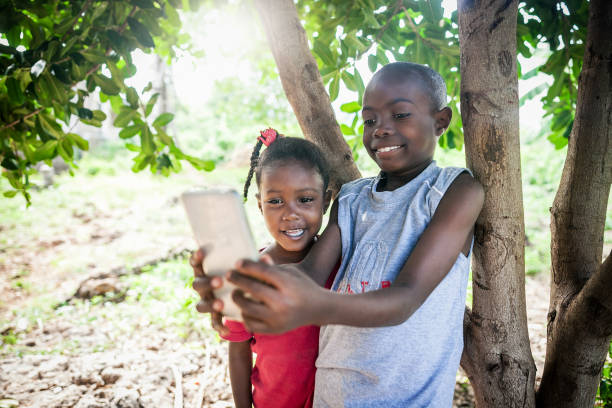 istock young african kids on mobile phone 1016454520