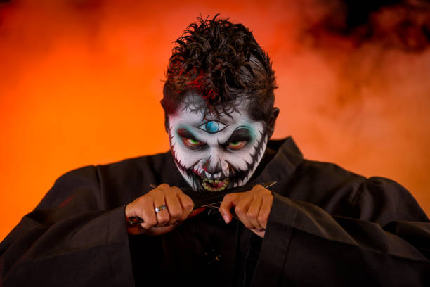 A male latino model with a modern and horror style approach to the Mayan God of the underworld, Xibalba. Shot against a black background with theatrical lighting and special effects