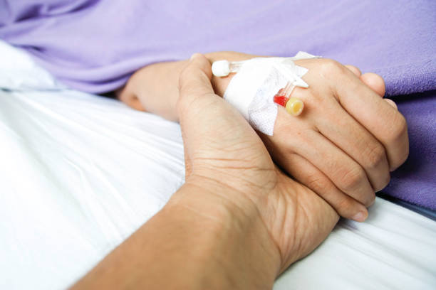 istock Holding patient hand in the hospital room 1016459782