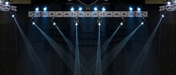 istock Luminous rays from concert lighting against a dark background, musical instrument concept 1016459974