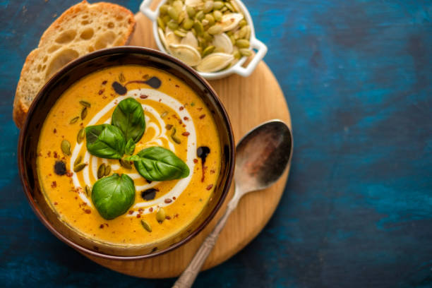 istock Delicious homemade pumpkin soup with basil leaves. Top view. Copyspace. 1016460210