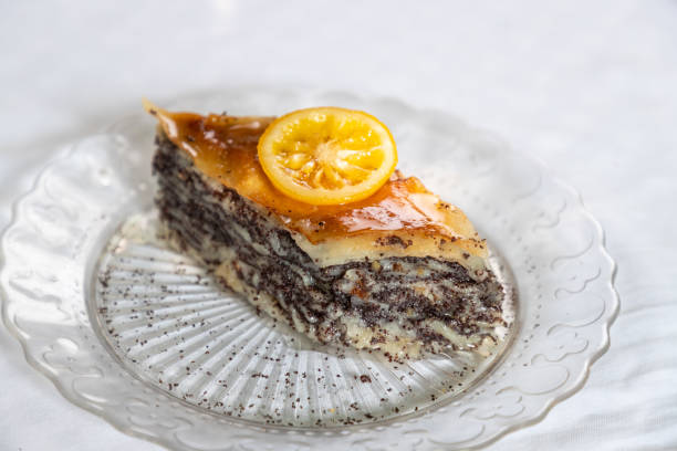 Serving of rhombus shaped poppy baklava with lemon slice