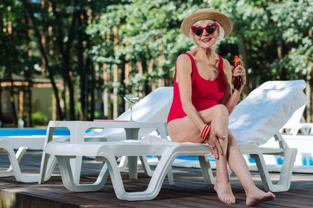 istock Healthy beaming retired woman wearing straw hat getting suntan 1016470854