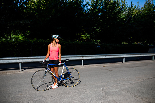 Athletic woman cycling road bike in the city