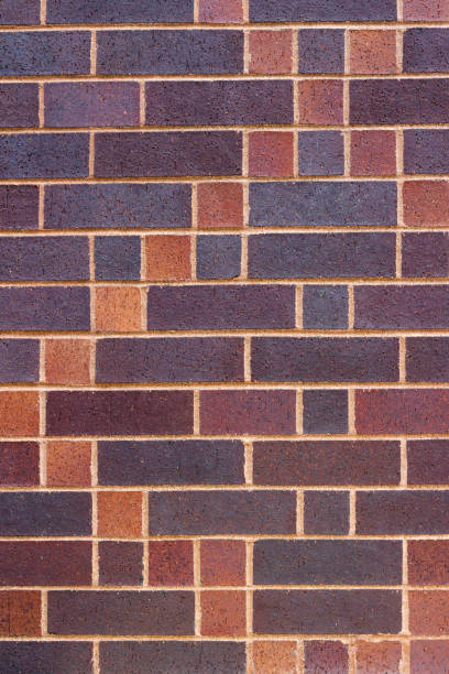 istock Vertical view of a colorful brick wall background with a patch quilt look 1016481636