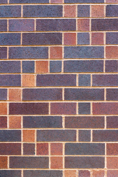 istock Vertical view of a colorful brick wall background with a patch quilt look 1016481766