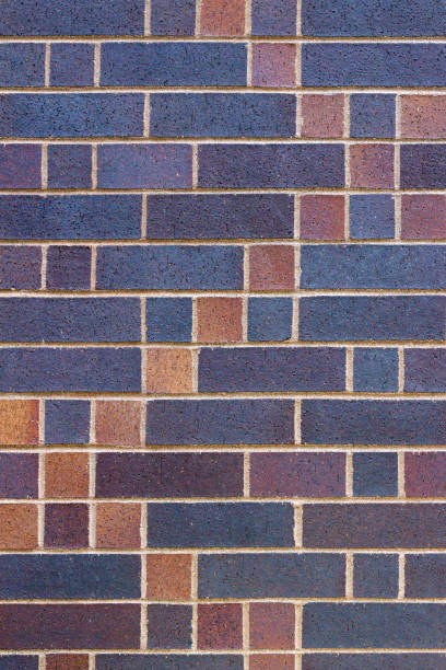istock Vertical view of a colorful brick wall background with a patch quilt look 1016481798