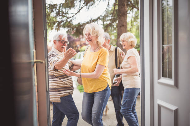 istock Group of seniors friendly embracing outdoors. 1016482004