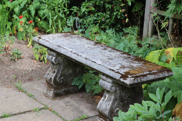 istock Ornamental old stone bench in formal garden 1016485500